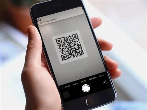 Smartphone camera scanning a QR code that displays a Base64 string on a screen below it